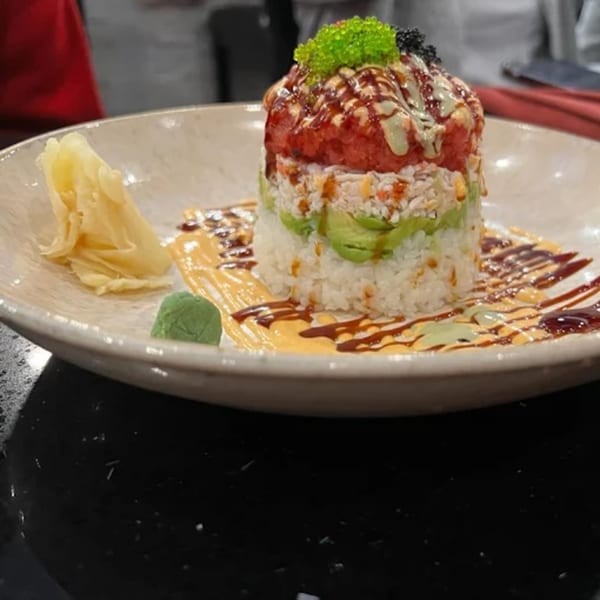 Zato Thai Cuisine & Sushi Bar's tuna sushi tower with avocado, rice, and sauces.