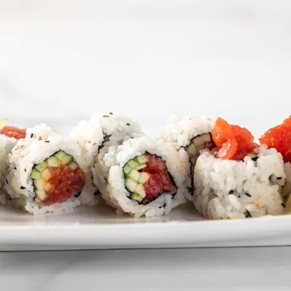 A close-up of Zato Thai Cuisine & Sushi Bar's sushi rolls with tuna, cucumber, and rice.