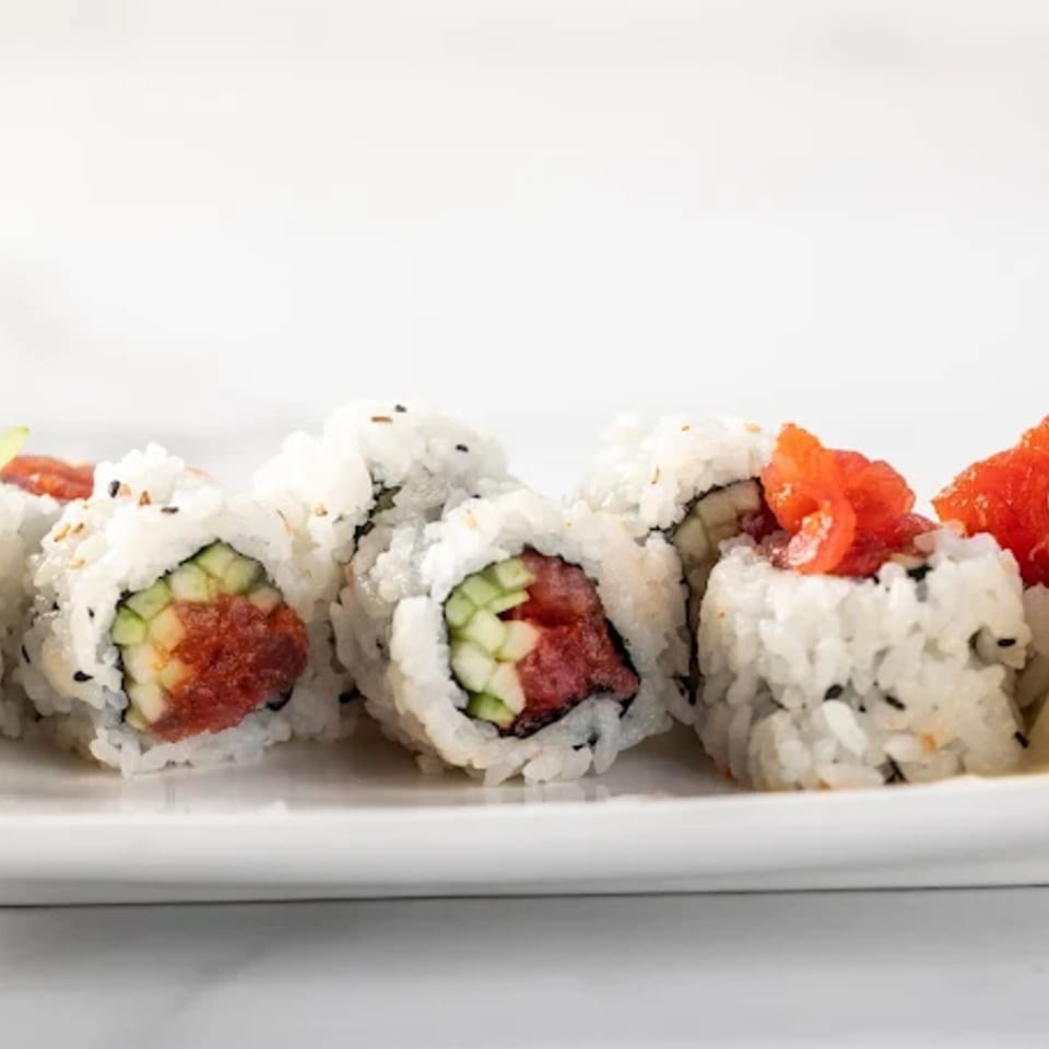 A close-up of Zato Thai Cuisine & Sushi Bar's sushi rolls with tuna, cucumber, and rice.