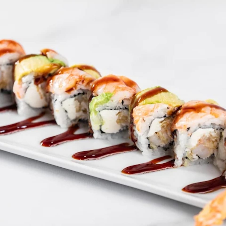A row of Zato Thai Cuisine & Sushi Bar's shrimp and avocado sushi rolls with sauce.