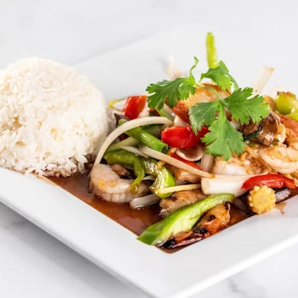 Zato Thai Cuisine's stir-fried shrimp and vegetables with rice on a white rectangular plate.