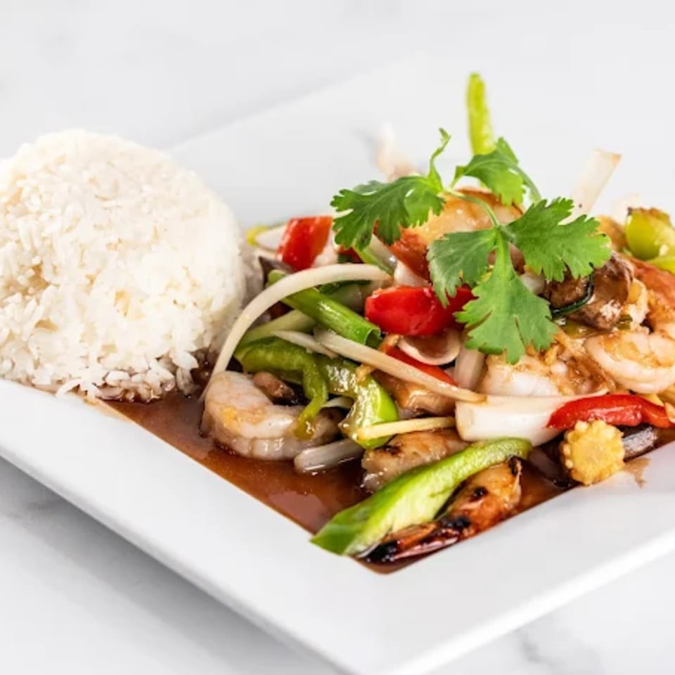 Zato Thai Cuisine's stir-fried shrimp and vegetables with rice on a white rectangular plate.